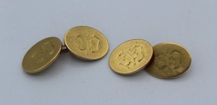 A pair of 18ct gold cufflinks of oval panel form with chain, engraved with lion and coronet