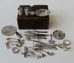 A mixed lot of small silver and white metal items, including tots, serviette rings, sugar nips,