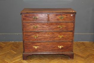 A late George III mahogany chest, the oblong top over two short and three long drawers with later