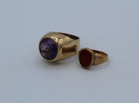 Two gentleman's yellow metal gemset rings, one features a round mixed cut amethyst, size T, gross