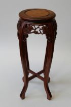 A modern Chinese carved hardwood jardinière stand, the circular top raised on cabriole legs,