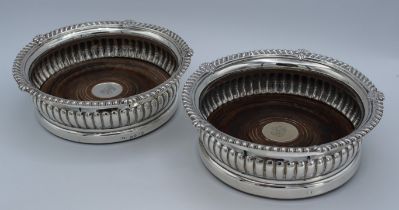 Paul Storr, a pair of George III silver bottle coasters, each with anthemion gadrooned rim, demi