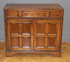 An early 20th century oak canteen chest with rising top over a pair of panel doors on bracket