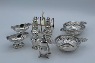 A pair of Edwardian silver pierced twin handled Quaich type dishes, a silver four slice toast