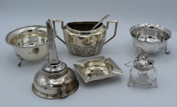 A George III silver wine funnel, London 1787, together with three silver sugar basins, a silver