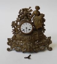 A mid 19th century gilt metal mantle clock decorated with a lady having a two train drum movement,