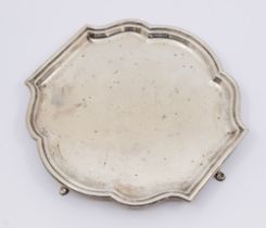 A George V silver four footed salver, of stepped curved simplistic design, hallmarked by Robert