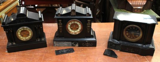 Three late 19th century French black slate mantel clocks, one with a black gilt face (3)