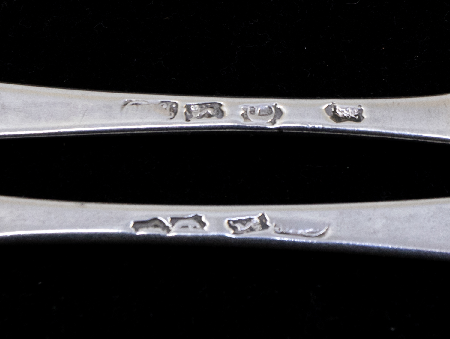 A pair of George II silver Hanoverian table spoons, each reverse handle engraved with a crest, - Image 2 of 3