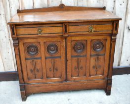 Early 20th century Oak Arts and Crafts sideboard with two drawers above two cupboard doors having