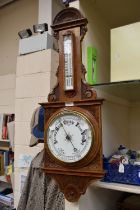 A 20th century oak cased carved barometer.