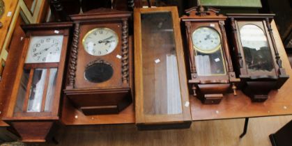 A collection of four early to mid 20th century 8-day wall clocks along with a clock case (5)