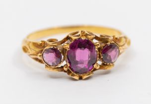 A 19th century stone set gold ring, comprising an oval mixed garnet, with small round mixed cut