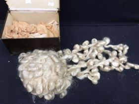 A boxed theatrical wig of cream/white colourway