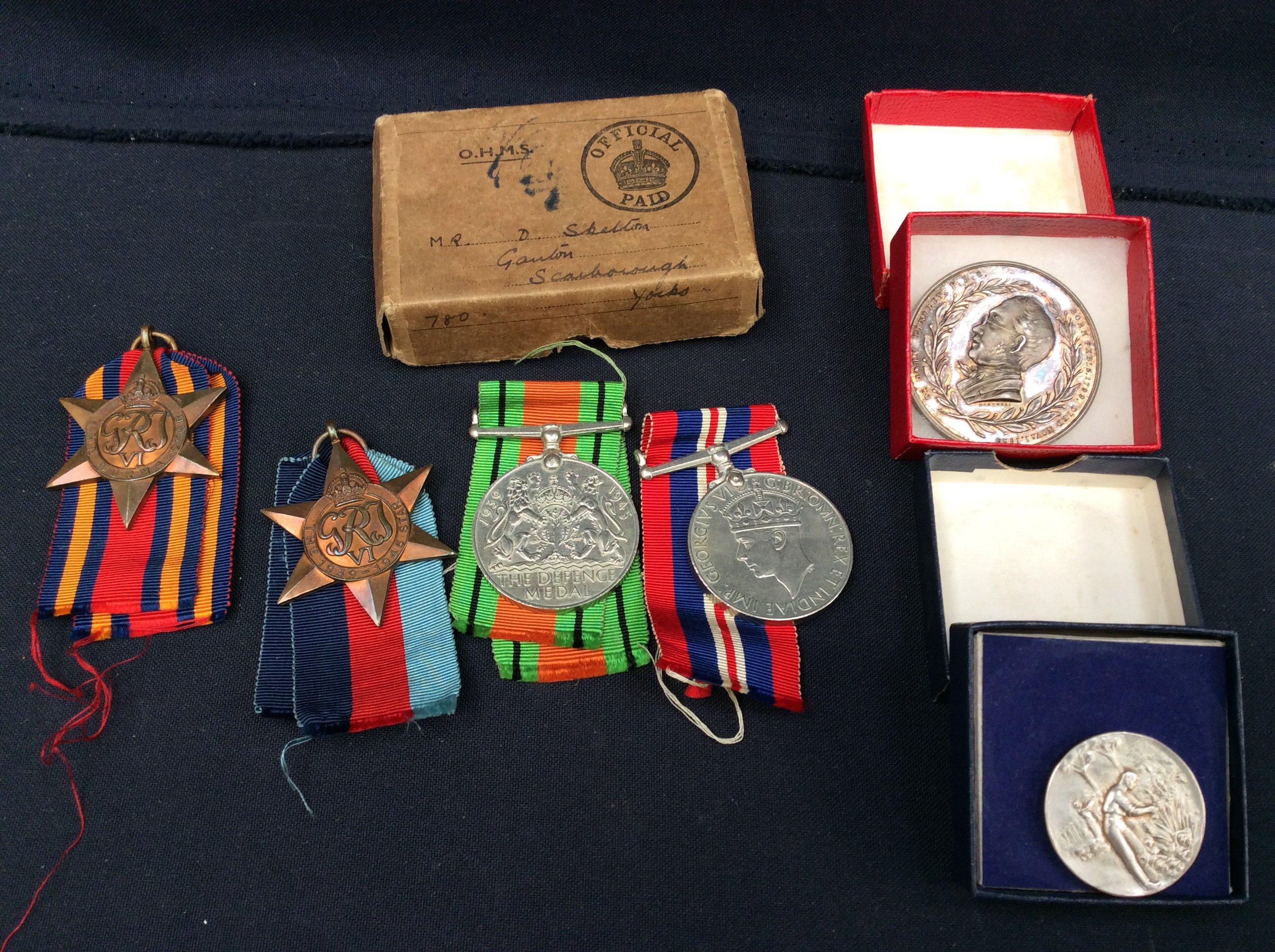 A small collection of WW2 War medals in original box to include; the 1939-45 War medal, The