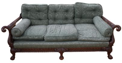 A bergere three-seater sofa, having ornate carved detail of eagle-headed arms, and foliate detail,