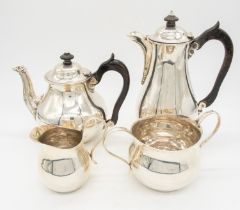 A George V matched silver tea set consisting of tea pot with ebonised wooden finial and handle, with