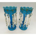 A pair of late Victorian blue glass lustres decorated with a band of flowers and gilt. All