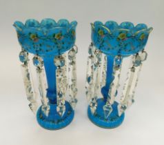 A pair of late Victorian blue glass lustres decorated with a band of flowers and gilt. All