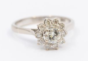 A diamond and 18ct flower head cluster ring,  comprising a central round brilliant cut diamond,