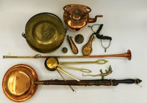 A collection of brass and copper wares to include; bed pans, hunting horn, jam pan, powder cases,