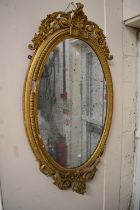 Early 19th century oval regency gilt gesso wall mirror with original pier glass.