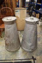 Two large aluminum milk churns with tops