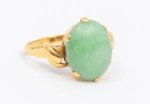 A jade and 22ct gold ring, comprising an oval cabochon jade approx 13mm, claw set, the shoulders