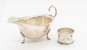 A George VI silver sauce boat, three footed, hallmarked Ernest W Haywood, Birmingham, 1940. Along