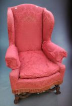 19th century reproduction of a 18th century wingback fireside chair with bow front.