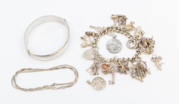 A small collection of silver jewellery to include a vintage charm bracelet with various charms,