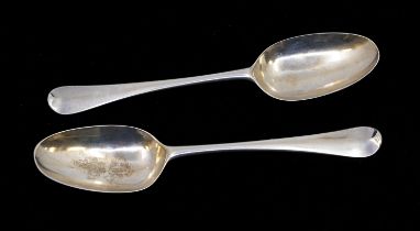 A pair of George II silver Hanoverian table spoons, each reverse handle engraved with a crest,