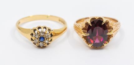 A garnet and 15ct gold dress ring, comprising an oval mixed cut garnet claw set to an engraved