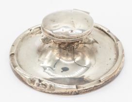 A George V silver large capstan inkwell, of circular form with hinged cover (broken hinge so cover