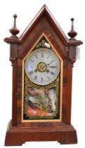 A 20th century mahogany and gold painted glass detailed mantel clock of stylised form.