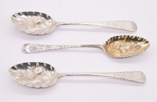 Three George III silver berry spoons to include; a Newcastle hallmarked with elaborate engraved