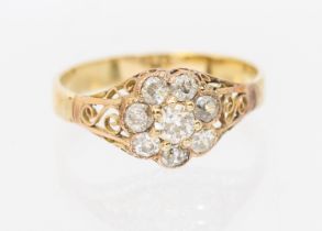 A diamond and gold ring, comprising a flower cluster of old cut diamonds, setting approx 8mm,