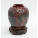 Ruskin - A bulbous high-fired ginger jar, without cover, having speckled moss like green glaze to