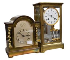 Tall early 20th century brass 8 day mantle clock, round face in glass case with roman numerals,
