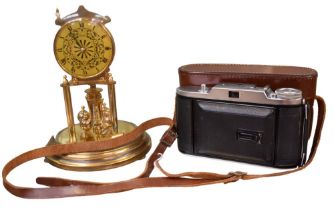 A mid 20th century domed Anniversary clock and a vintage camera