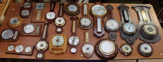 A collection of early to late 20th century barometers in oak and mahogany (1 box)