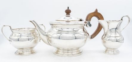 A Queen Elizabeth II silver tea set, comprising tea pot, sugar bowl and milk jug, the tea pot having