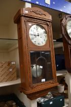 1930s light oak wall-hanging 8-day clock, along with a carved oak barometer