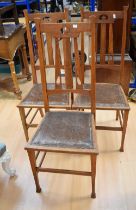 Three Oak Arts and Crafts dining chairs.