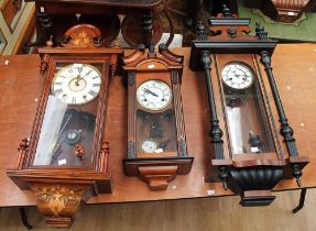 Edwardian mahogany inlaid 8-day wall clock, a mahogany and ebonised wall clock, and a later 20th