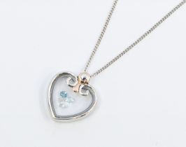 A Clogau silver and gold dancing stones pendant in the form of a heart, with blue topaz within a