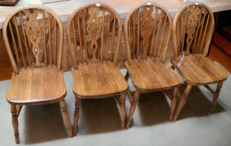 A mid 20th century solid oak refectory kitchen table,  along with four oak spindle back chairs