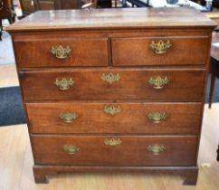 An early George III English oak tall chest of two above three drawers with brass swing handles on