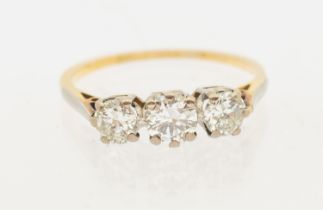 A three stone diamond and 18ct gold ring, comprising three graduated round brilliant cut diamonds,