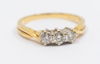 A diamond three stone 18ct gold ring, comprising three round brilliant cut diamonds, total diamond